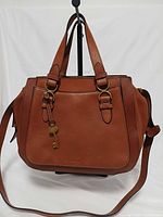 Front view showing leather, handles, hardware, key charm