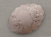 Front view showing floral etching and scalloped edge