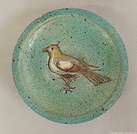 Top view showing full ashtray and bird motif