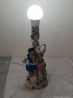 Lamp lit showing full figurine and socket
