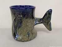 Front view of whale-tail pottery mug