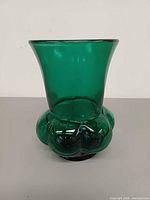 front view of green glass vase showing flared rim and lobed base