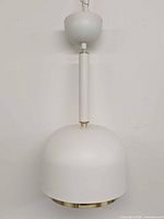 Front view of white dome pendant lamp with canopy and downrod