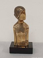 Front view of bronze bust on black base