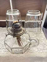 Oil lamp with burner and two chimneys displayed