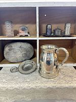 Full lot showing tankard, tea strainer, hobnail shaker, napkin holder, condiment set on tray, and Maison Centrale pewter box