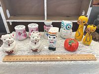 Group image of all ten shakers displayed with ruler for scale