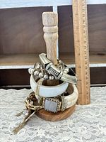 Stack of mixed bangles and bracelets on wooden stand