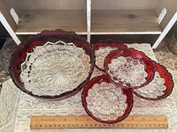 full view of all five bowls showing pattern and color, ruler for scale