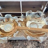 Both amber carnival glass bowls side-by-side with ruler showing diameter