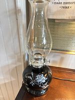 Full view of lamp showing black glass font, clear chimney, cord