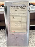 Front view showing dispenser closed with receipt pad visible through window