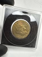 Coin in holder showing obverse