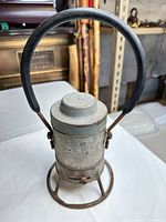 Full view of lantern with handle raised showing overall form