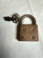 Front view of padlock with keys attached