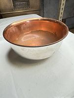 Oblique view showing silver-plated exterior and copper interior of bowl