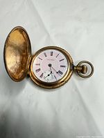 Open watch showing dial, hunter cover open