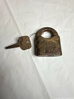 Corbin brass padlock with key attached
