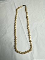 Full view of entire pearl necklace laid flat