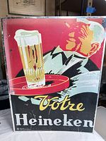 Front view of Heineken aluminum sign with waiter graphic and text