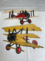 Both cast metal biplane wall plaques full view
