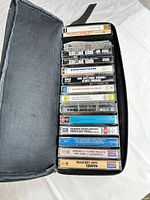 Open cassette carrying case displaying twelve cassettes