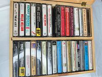 Overall view of two rows of cassette tapes in wooden holder