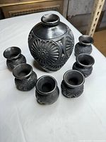 Full set showing one large vase and six small vases/cups
