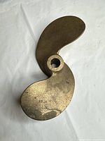 Top view of bronze 2-blade propeller showing hub and blade curvature