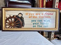 Full view of carved wooden nautical wall plaque showing captain, wheel, text and rope border