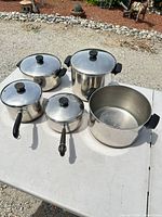 Group shot of four pots showing size variety and stainless finish