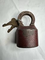 Padlock front view showing red body, shackle, keys