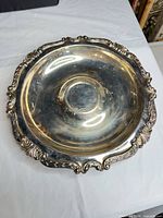 Overhead view of silver-plated round tray showing entire shape and ornate border