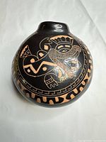 Overall view of rounded blackware jar showing incised indigenous motif and burnished finish