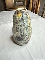 front view of mottled green ceramic vase