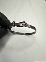 Full view of bangle showing belt-buckle design and hinge