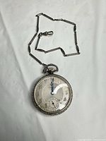Full view of pocket watch with attached chain