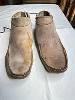 Top view of both boots showing toe stitching, leather wear and color