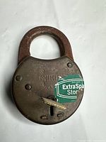 Front of brass padlock showing branding and keyway