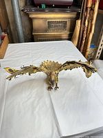 Front view of gilded bronze eagle with wings spread on tabletop