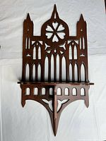 Full view of wall shelf front showing Gothic cutouts and lower support