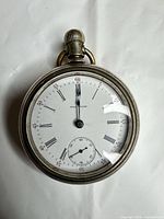 Front view of Waltham pocket watch showing dial, hands, sub-seconds and case detail