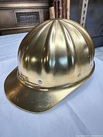 Front and side profile of gold Wattis hard hat