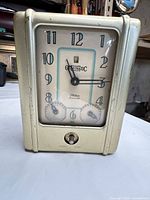 Front view showing full clock face, branding, dual dials and high-low knob