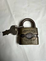 Front view of Yale Fidelity brass padlock with two keys attached