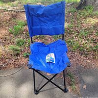 Assembled blue folding chair outdoors showing full structure