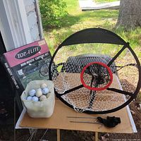 Box and assembled Top Flite Mini-Mouth chipping net, bag of golf balls, stakes