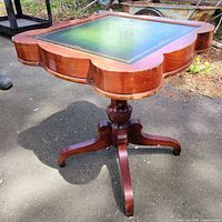 Full view of games table showing cherry finish, pedestal base and quatrefoil top