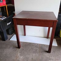 Front view of the rectangular cherry finish wood table showing legs and apron