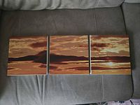 Front view of three square sunset prints laid side by side